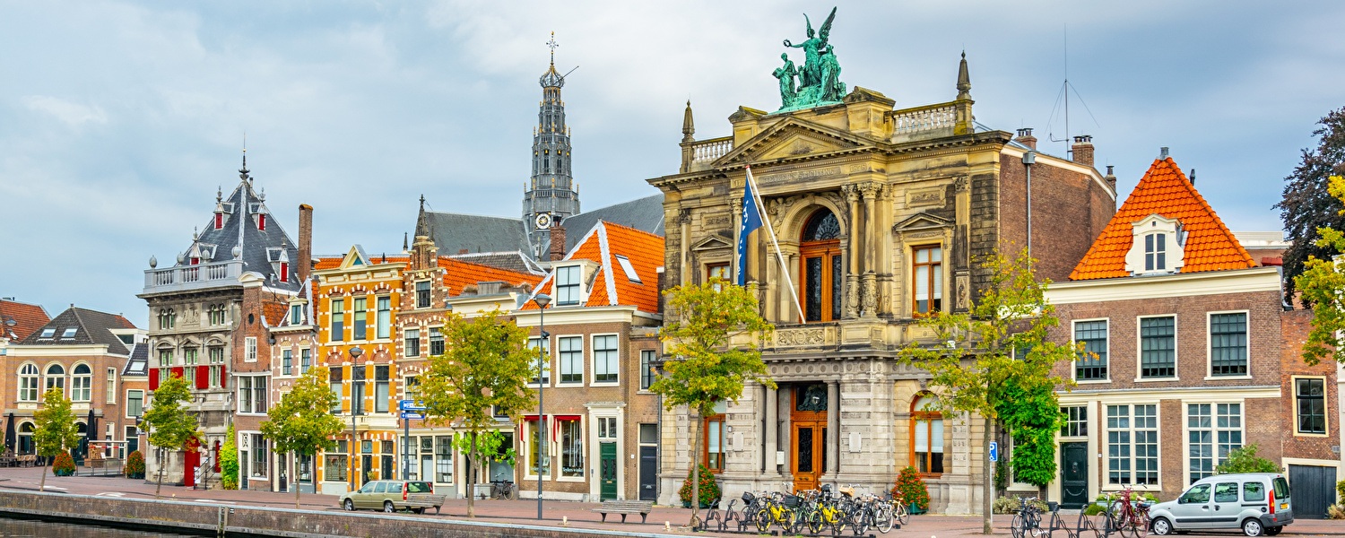 City houses along the water of Haarlem next to it is the Teyler Museum