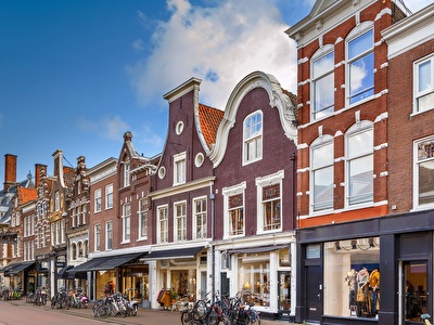 Shopping street in Haarlem with historic buildings and bicycles