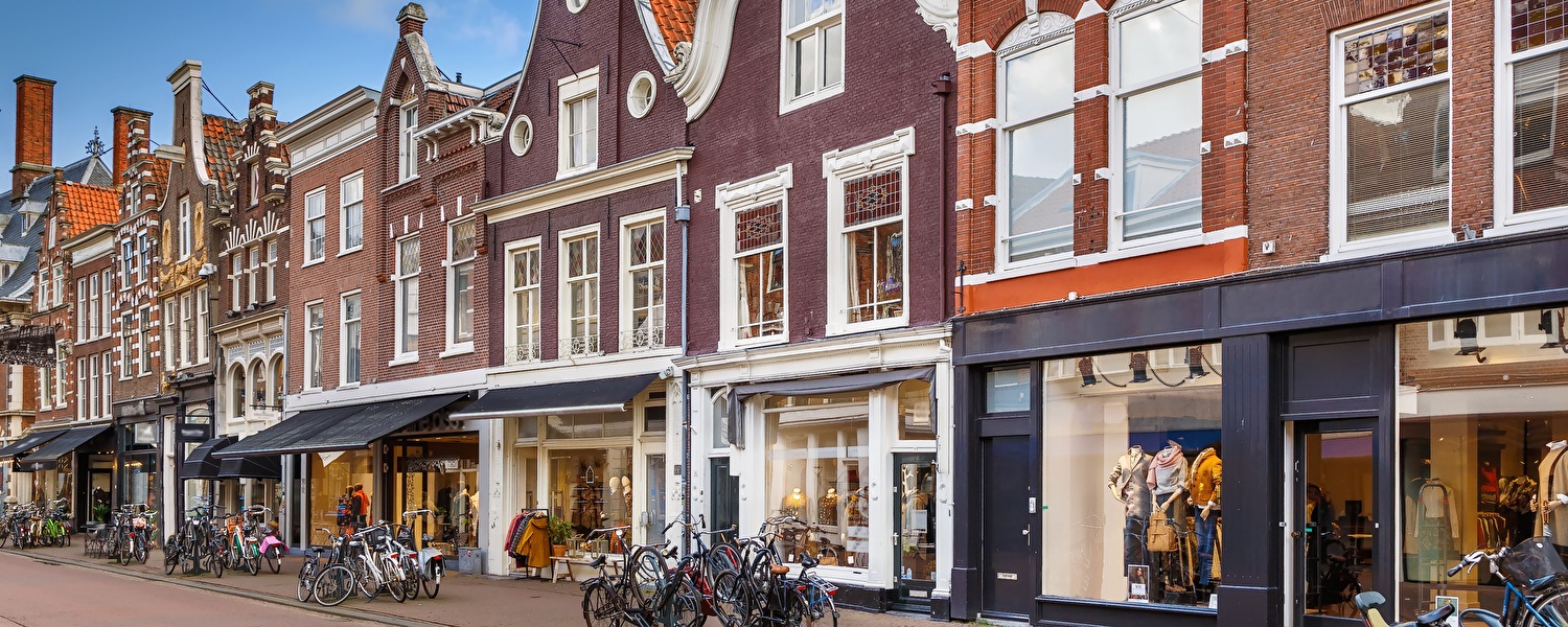 Shopping street in Haarlem with historic buildings and bicycles
